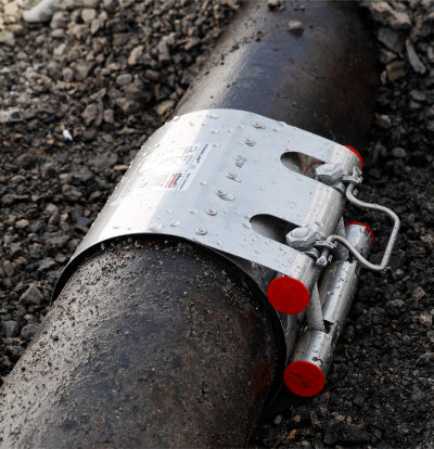 Wrap-around pipe repair clamp on damaged stainless steel pipework